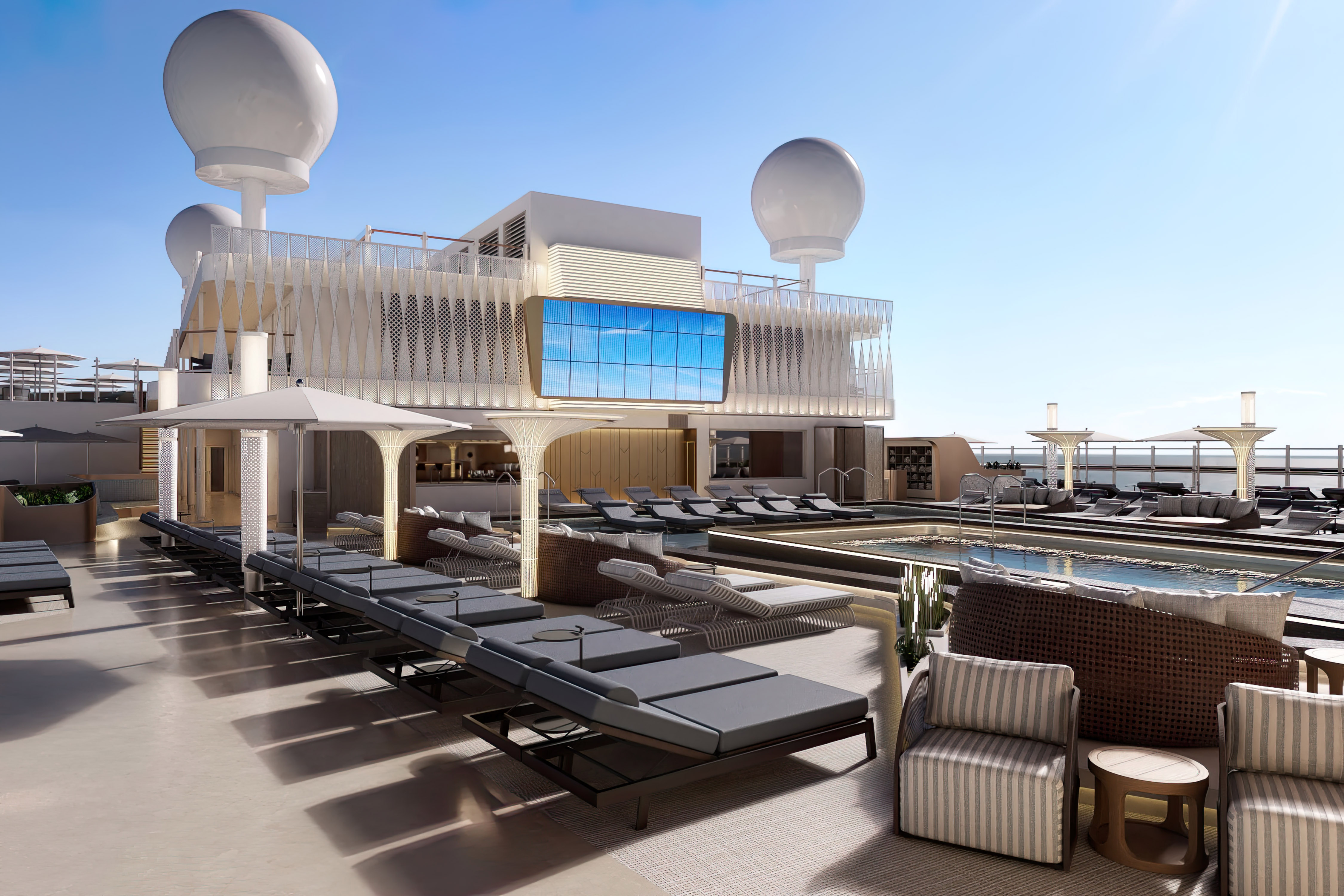 Relaxa i solsängarna vid huvudpoolen