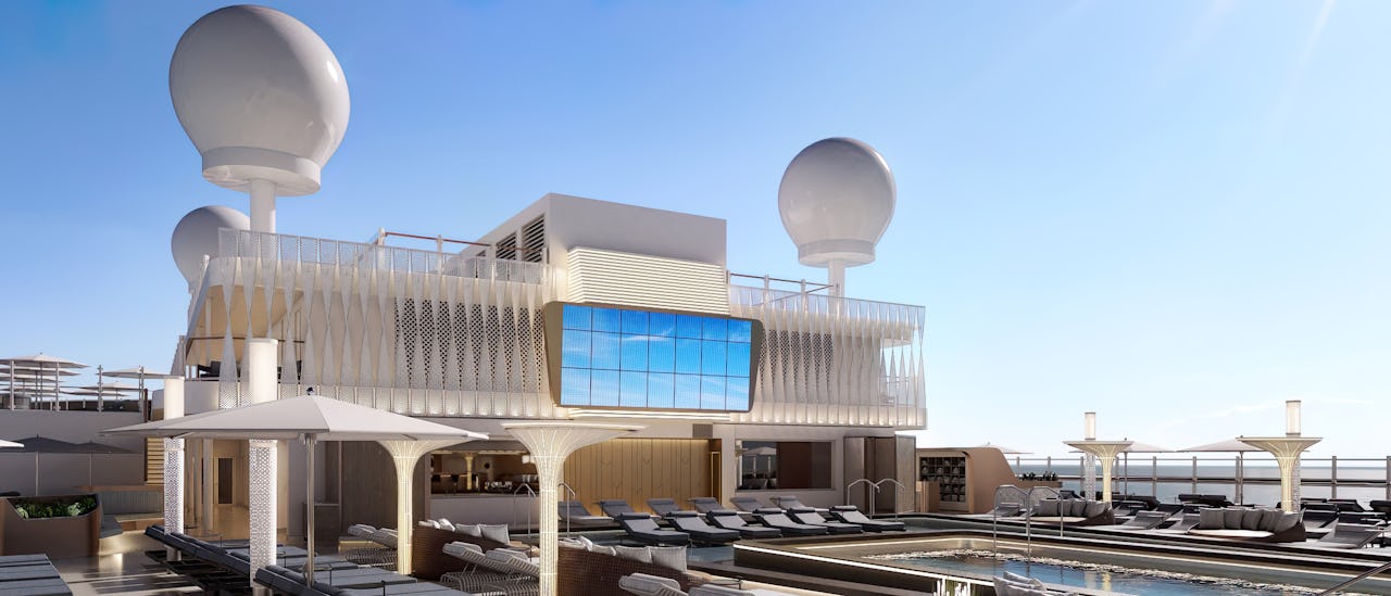 Relaxa i solsängarna vid huvudpoolen