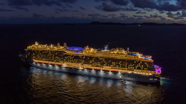 Bilden visar ett upplyst kryssningsfartyg från P&O Cruises under kvällen