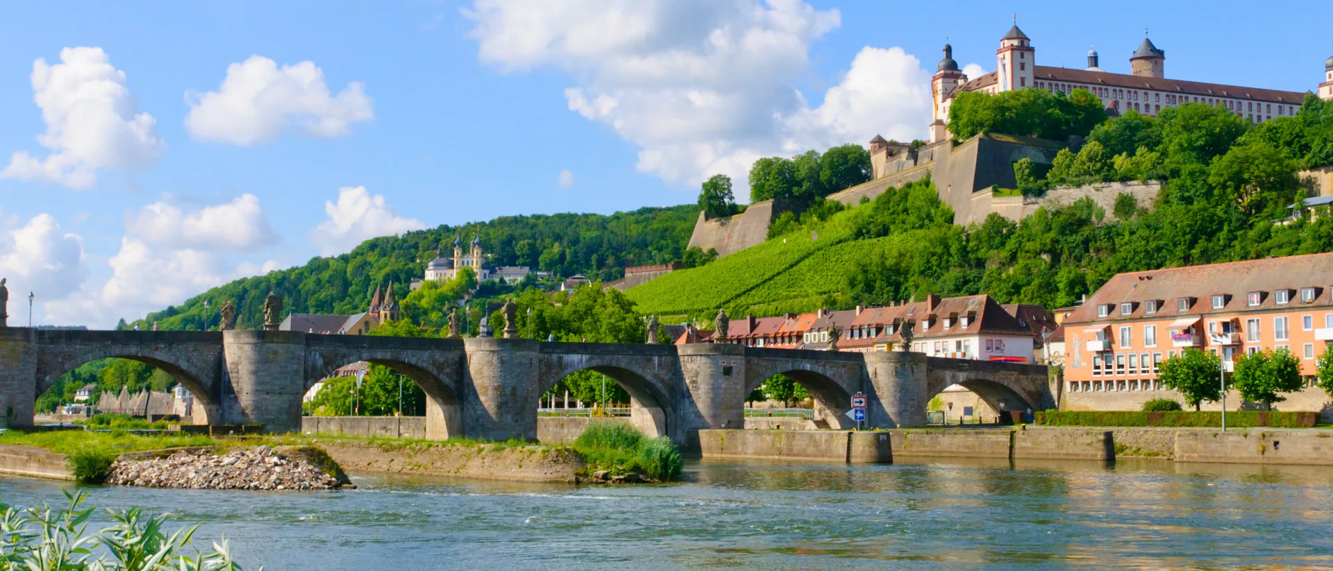 Bilden visar vackra floden Main som rinner genom en stad i Tyskland. Upplev en sagolik flodkryssning på Main.