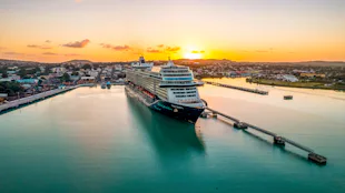 Mein Schiff 1 vid hamn i solnedgång